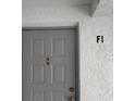 Condo unit with a neutral color front door at 1258 Pine Ridge W Cir # F1, Tarpon Springs, FL 34688