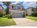 Charming home featuring a two-car garage, fresh landscaping, and a cozy front entrance at 13722 Lakemont Dr, Hudson, FL 34669