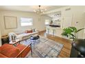 Bright living room with modern lighting, open to the kitchen with counter seating and stylish decor at 1416 55Th N Ave, St Petersburg, FL 33703