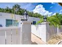 Well-maintained condo exterior with decorative outdoor lighting and white picket fence at 1655 S Highland Ave # B118, Clearwater, FL 33756