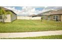 The expansive backyard has a well-maintained lawn and a white vinyl fence at 16623 Carlton Pond St, Wimauma, FL 33598