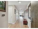 Bright hallway featuring hardwood floors and tastefully decorated walls, leading to the living area at 199 Dali Blvd # 607, St Petersburg, FL 33701