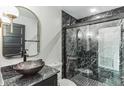 Modern bathroom featuring black marble walls and a sleek vessel sink at 2010 4Th W Ave, Palmetto, FL 34221