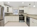 Bright kitchen with granite counters, stainless steel appliances, and modern cabinetry at 212 W Humphrey St, Tampa, FL 33604