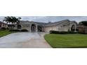 Stunning single-story home featuring a spacious driveway and meticulously maintained front yard at 2635 Jarvis Cir, Palm Harbor, FL 34683