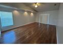 Bright, open living area with hardwood floors, a ceiling fan, recessed lights, and large sliding doors at 2635 Jarvis Cir, Palm Harbor, FL 34683