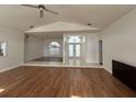 Open living area with wood flooring, arched windows, and entry to bathroom area at 2635 Jarvis Cir, Palm Harbor, FL 34683