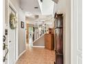 Bright foyer featuring tile flooring, staircase, and an antique grandfather clock, creating a welcoming entrance at 3484 Primrose Way, Palm Harbor, FL 34683