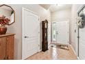 Inviting foyer with neutral walls, tiled flooring, Grandfather clock and an abundance of natural light at 3484 Primrose Way, Palm Harbor, FL 34683