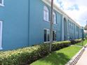 Charming building exterior featuring a blue facade, lush green landscaping, and well-maintained walkways at 364 115Th N Ave # 1, St Petersburg, FL 33716