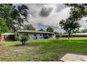 A serene backyard with a well-manicured lawn offers ample space for relaxation and outdoor activities at 38320 14Th Ave, Zephyrhills, FL 33542