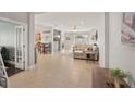 Spacious open-concept living room with tile flooring, neutral tones and ample natural light at 4020 Cottage Hill Ave, Parrish, FL 34219