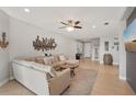 Comfortable living room with tile floors, a cozy sectional, and modern decorative accents at 4020 Cottage Hill Ave, Parrish, FL 34219