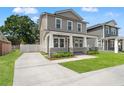 Lovely two-story home featuring a welcoming front porch, lush lawn, and long private driveway at 406 E Selma Ave, Tampa, FL 33603