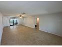 Expansive living room featuring tile flooring and sliding glass doors to the back patio at 422 Crosswinds Dr, Palm Harbor, FL 34683