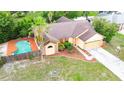 Aerial view of a lovely home with a backyard pool and lush landscaping at 4744 Burlington Rd, Land O Lakes, FL 34639