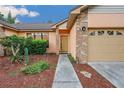 Welcoming front entrance with desert landscaping and a pathway leading to the door at 4744 Burlington Rd, Land O Lakes, FL 34639