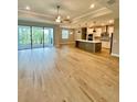 Spacious living room with open floor plan, wood floors, and natural light at 4773 Hickory Oak Dr, Brooksville, FL 34601