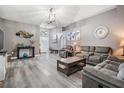 Spacious living room with vaulted ceiling, gray walls, and wood look flooring at 5334 Tummel Ct, Wesley Chapel, FL 33545