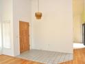 Bright foyer features stylish chandelier, tile floors, and wood front door at 5530 Salem Square N Dr, Palm Harbor, FL 34685