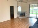 Inviting living room featuring hardwood floors, a fireplace, and a sliding glass door to the patio at 5530 Salem Square N Dr, Palm Harbor, FL 34685