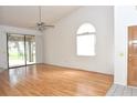 Light-filled living room with sliding glass doors and ceiling fan at 5530 Salem Square N Dr, Palm Harbor, FL 34685