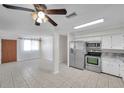 Open kitchen featuring stainless steel appliances, light countertops, and a view into the living area at 6497 43Rd N Ave, Kenneth City, FL 33709