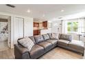 Inviting living room featuring stylish wood-look tile flooring and a comfortable sectional sofa at 6706 S Trask St, Tampa, FL 33616