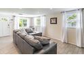 Bright living room with large windows, neutral decor, and a cozy seating arrangement at 6706 S Trask St, Tampa, FL 33616