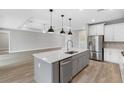 Modern kitchen featuring a center island, stainless steel appliances, and an open floor plan at 6757 Summit View Dr, Brooksville, FL 34601