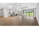 Spacious living room featuring hardwood floors, modern ceiling, and sliding glass doors at 6757 Summit View Dr, Brooksville, FL 34601