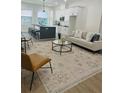 Open-concept living room with modern furnishings and a seamless flow into the adjacent kitchen at 723 W 113Th Ave, Tampa, FL 33612