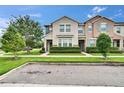 Charming two-story townhome featuring a well-manicured lawn and lush green hedges at 7325 Parkshore Dr, Apollo Beach, FL 33572