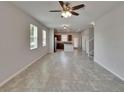 Bright and spacious living room with ceramic tile flooring leading to kitchen at 7325 Parkshore Dr, Apollo Beach, FL 33572