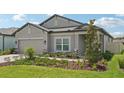 Well-maintained single-story house with a manicured front yard and an attached garage at 810 Hillshire Pl, Spring Hill, FL 34609