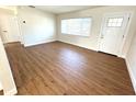 Bright living room featuring wood-look flooring, ample natural light, and a welcoming entrance at 814 19Th Sw St, Largo, FL 33770