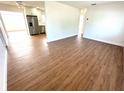 Open floor plan featuring a spacious living area with wood-look flooring leading to the modern kitchen at 814 19Th Sw St, Largo, FL 33770