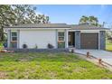 Inviting single-story home with stone accents, fresh paint, and well-maintained landscaping at 9511 N Hyaleah Rd, Tampa, FL 33617