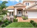 Inviting front entrance with lush landscaping and a charming front patio, creating a welcoming curb appeal at 9800 Sago Point Dr, Seminole, FL 33777