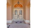 Close up of the home's double front door and brick entryway with a decorative welcome mat at 10228 Yellow Pine Way, Hudson, FL 34667