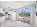 Eat in kitchen boasts ample white cabinetry, stainless appliances, and sliding doors for easy access to outdoor patio at 10599 111Th N Ave, Largo, FL 33773
