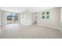 Bright living room featuring tile flooring, neutral walls, and a sliding glass door to the outdoor patio at 10599 111Th N Ave, Largo, FL 33773