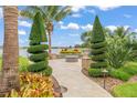 Landscaped backyard featuring a fire pit, lake view and custom landscaping at 11603 Heron Watch Pl, Riverview, FL 33569
