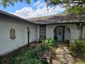 The home has a charming front entrance with detailed stone walkway and decorative plants at 16134 Ravendale Dr, Tampa, FL 33618