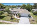 Well-maintained home with a two-car garage, manicured landscaping, arched entryway, and a welcoming curb appeal at 162 Lagoon Way, Palm Harbor, FL 34684