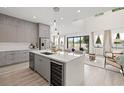 Open-concept kitchen featuring a center island with a wine cooler, and seamlessly flows into the living area at 1625 55Th S St, Gulfport, FL 33707
