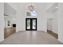 Bright foyer with high ceilings, double doors, and views to the living room at 16317 Colwood Dr, Odessa, FL 33556
