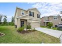 Charming two-story home featuring a two-car garage, stone accents, and a well-maintained lawn at 1680 Hazy Sea Dr, Plant City, FL 33565