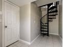 Unique interior view highlighting a spiral staircase adjacent to a white entry door at 1858 Michigan Ne Ave, St Petersburg, FL 33703