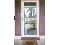 Inviting entryway with a storm door and charming brown shutters at 19029 Us Highway 19 N # 3-1, Clearwater, FL 33764